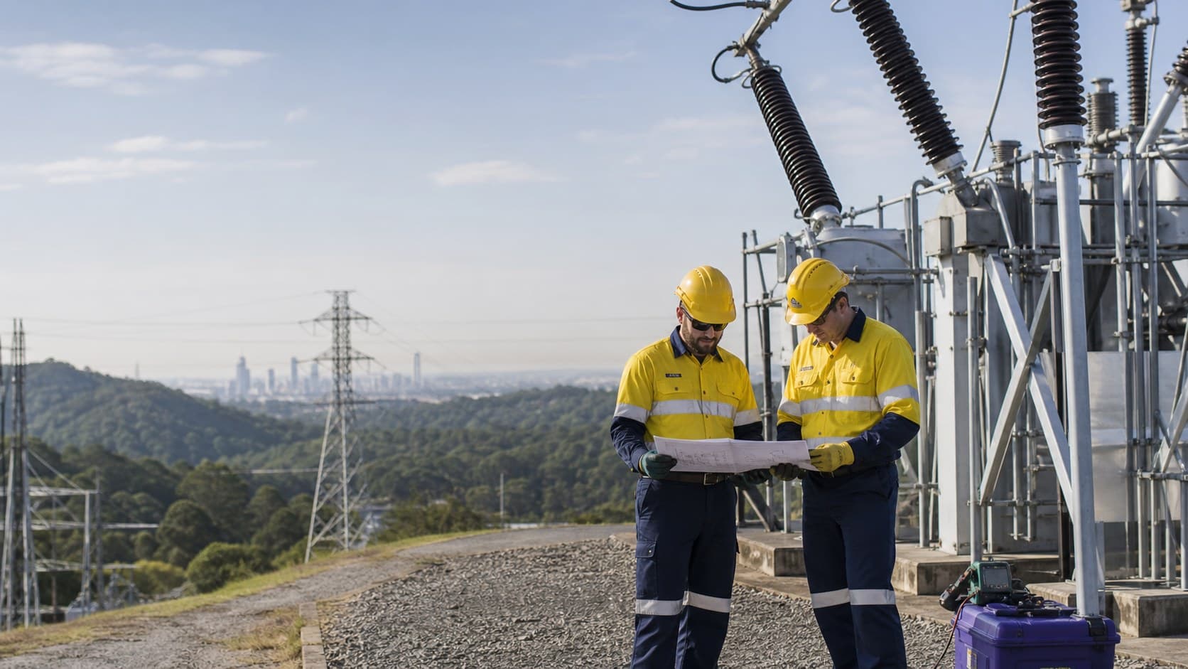 A line worker installing a transformer on a utility pole
